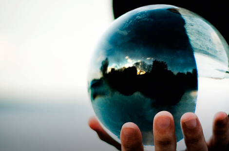 This is a photo of a man holding a crystal ball.